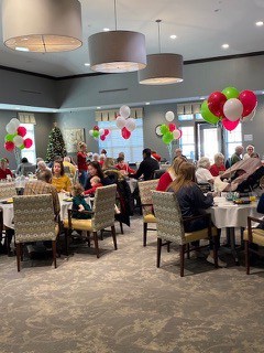 A Christmas Party with Santa at Traditions of Columbus, with red, green, and white balloons around the tables.