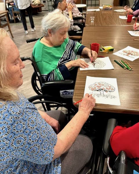 Senior living residents doing fall arts and crafts activities